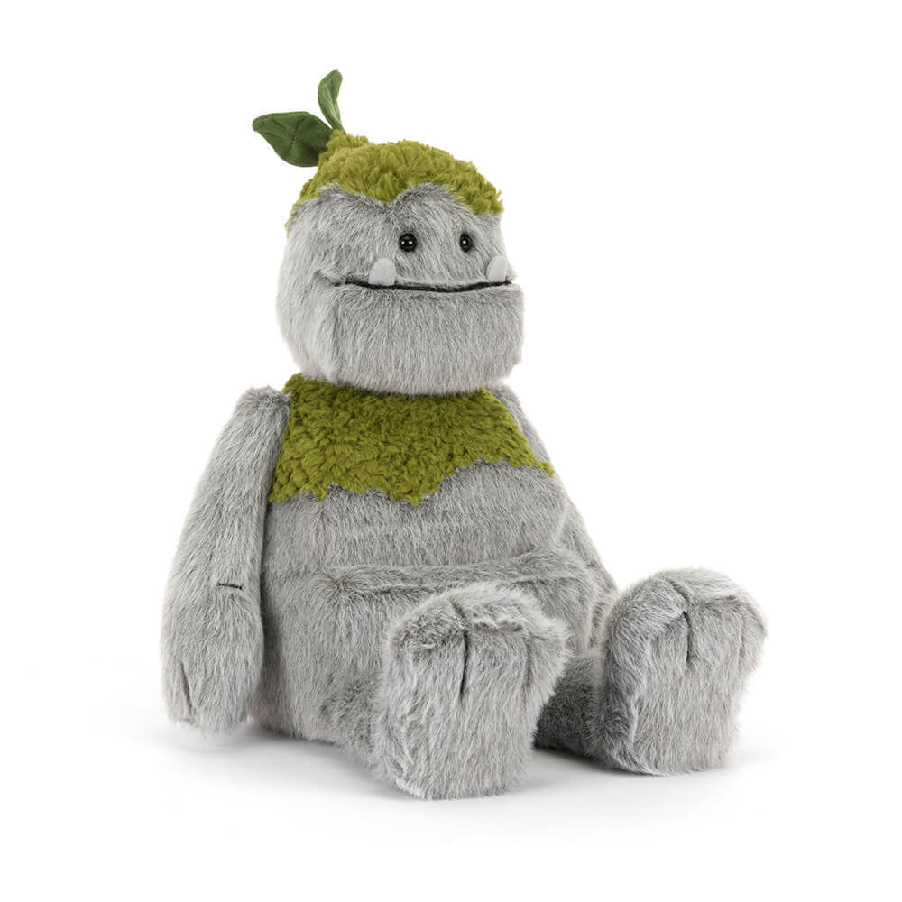 A side angled photo of a grey & green Rocketon plush toy creature on a white background.