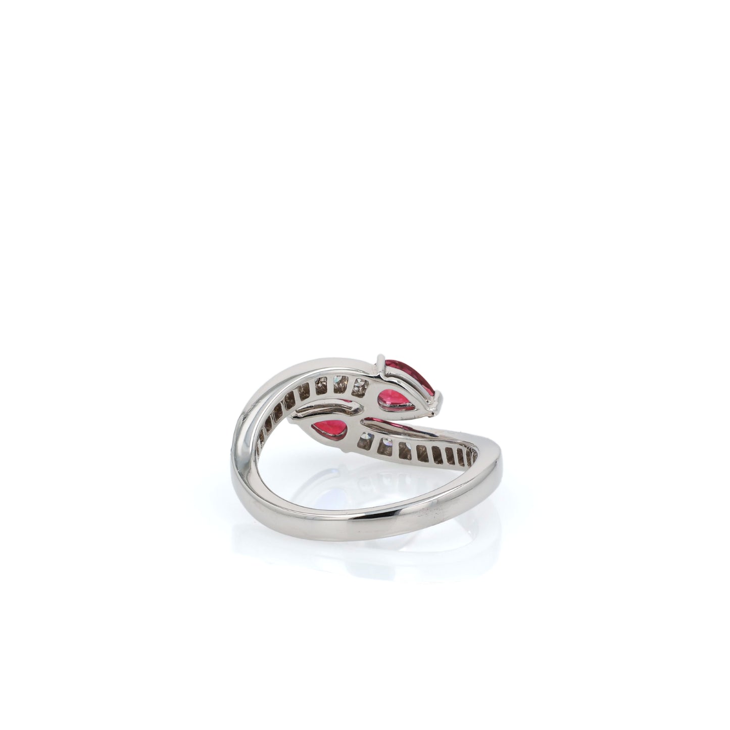 White gold diamond ring with pear shaped rubies on a white background