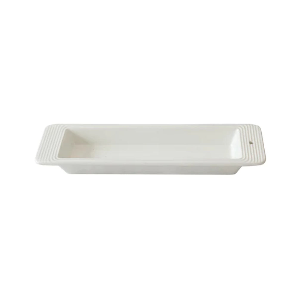 Rectangular white ceramic tray with textured border on a white background