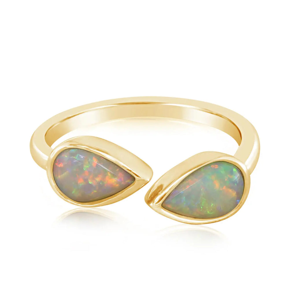 Gold ring with opal stones on a white background