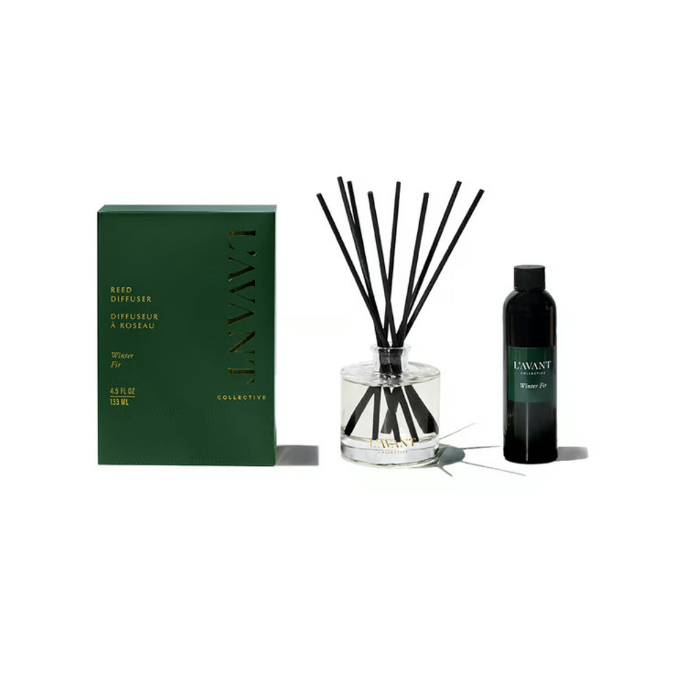 L'Avant Uniquely reed diffuser set featuring a dark green box, a clear glass bottle with black reeds, and a black liquid bottle on a white background.