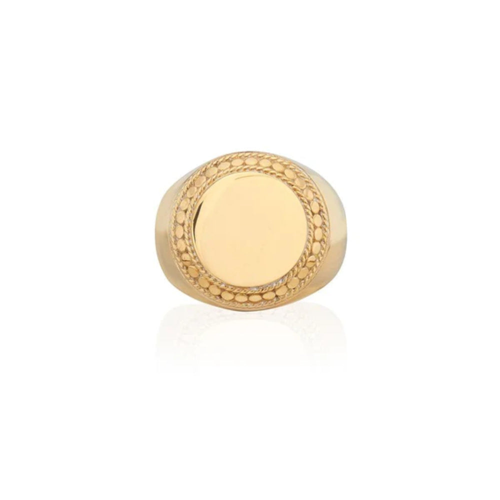 Gold ring with intricate design  signet ring on a white background