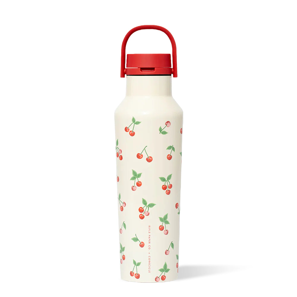 A cream colored water bottle with red cherries and a red lid on a white background. 