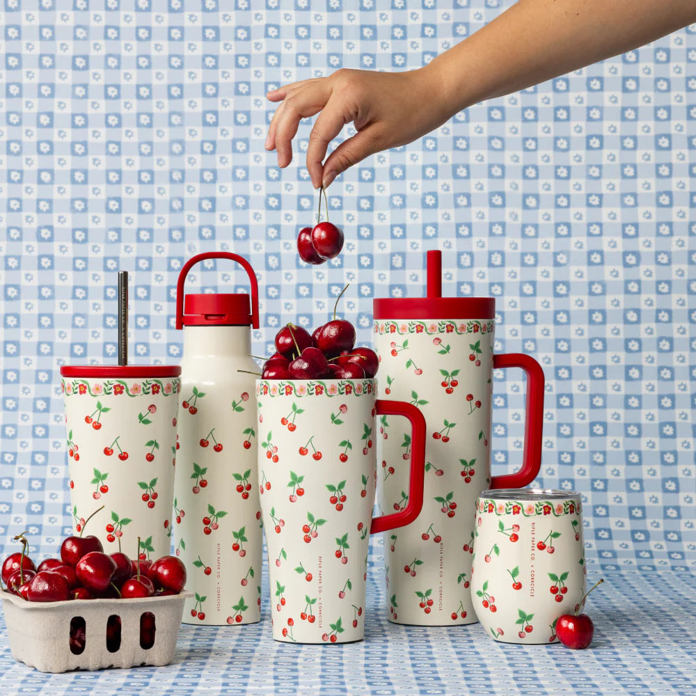 Tumblers with a cherry design on a patterned blue and white background