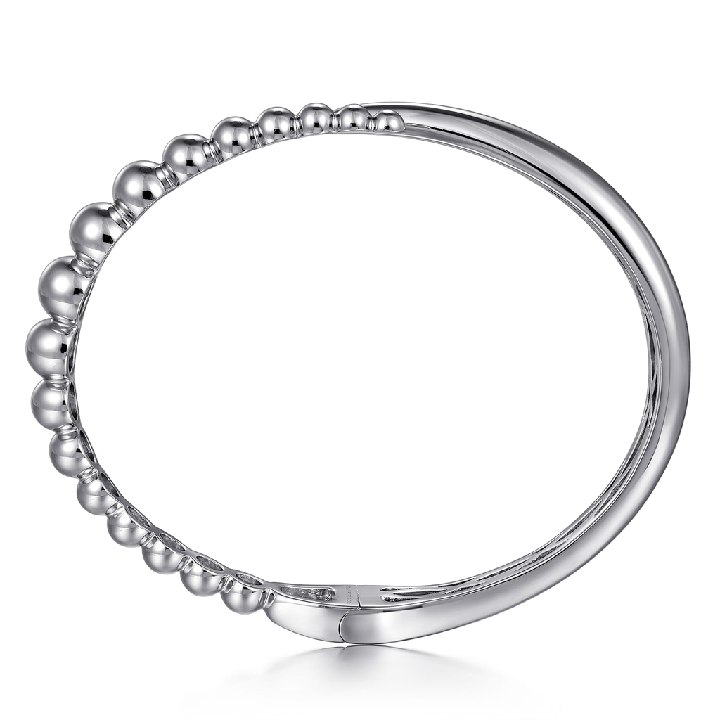 Silver ring with beaded design on a white background