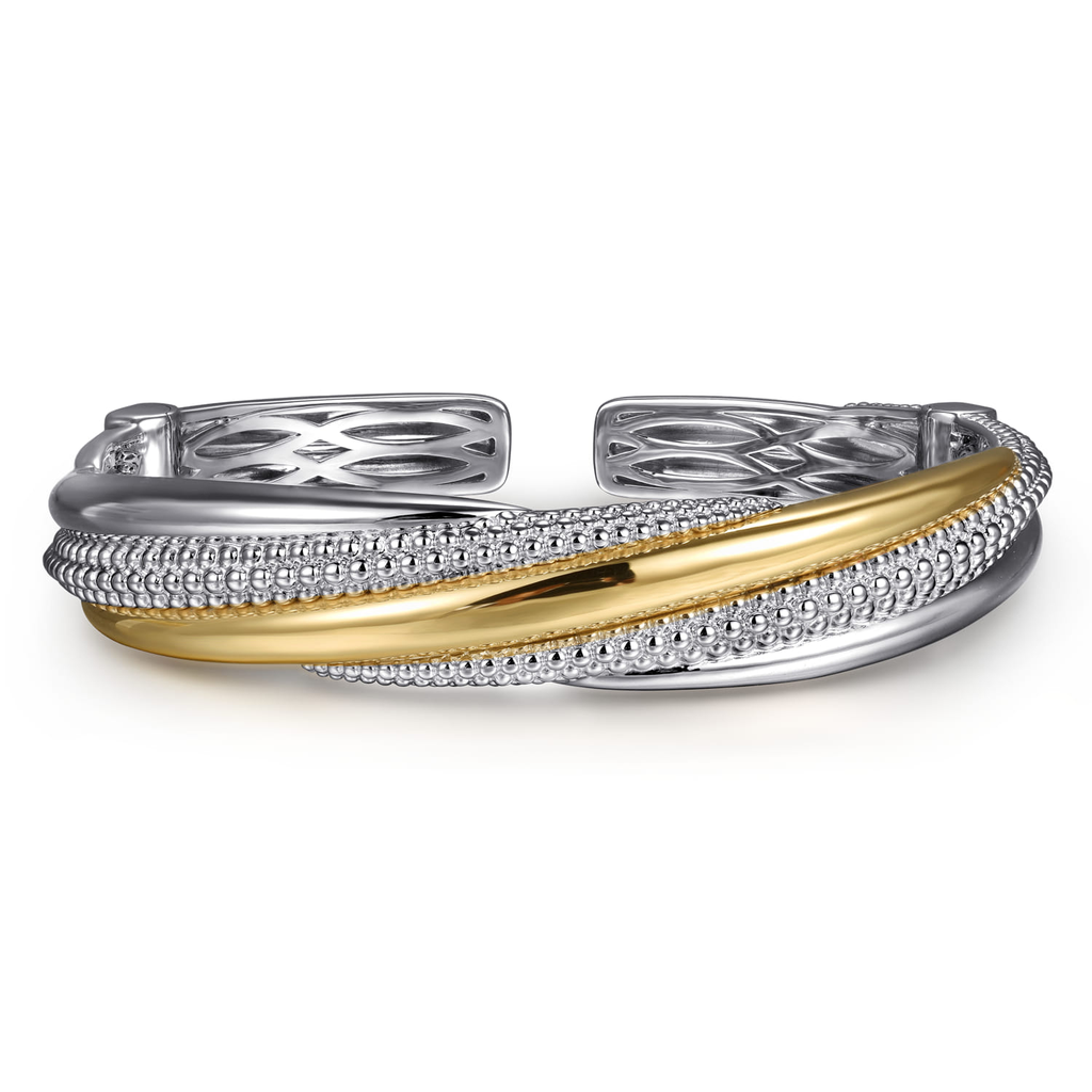 Gold and silver bracelet on a white background