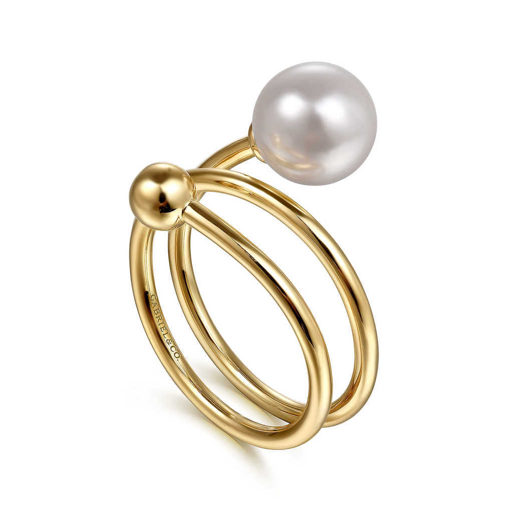 Gold ring with a pearl on a white background