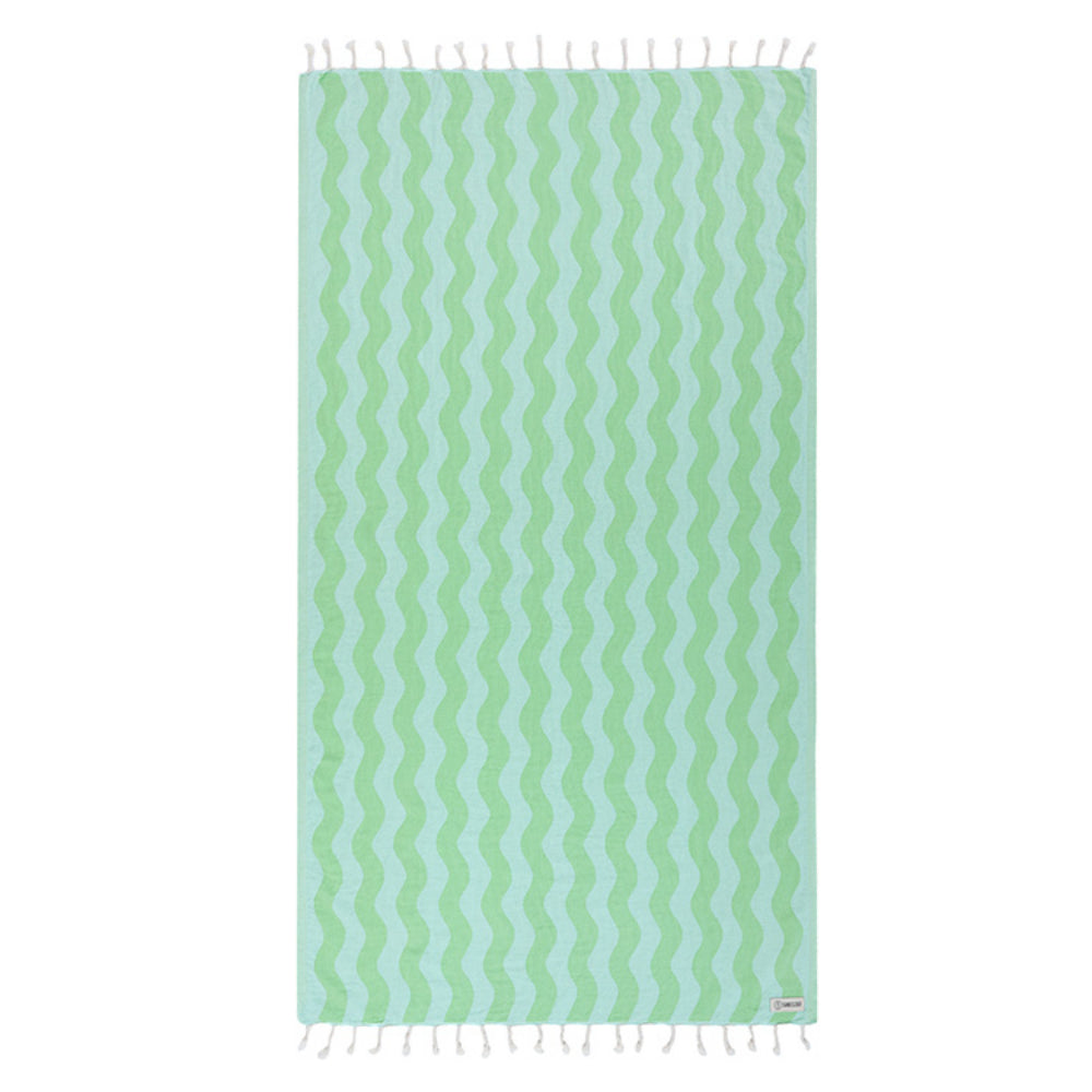 Lime green & blue wavy striped beach towel with white tassel edge on a white background.