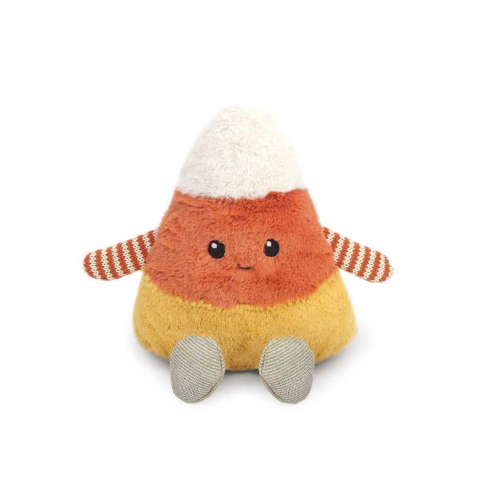 Toy candy corn with a smiling face on a white background