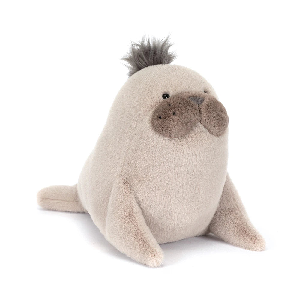 A angled side photo of a grey sea lion plush toy on a white backround 