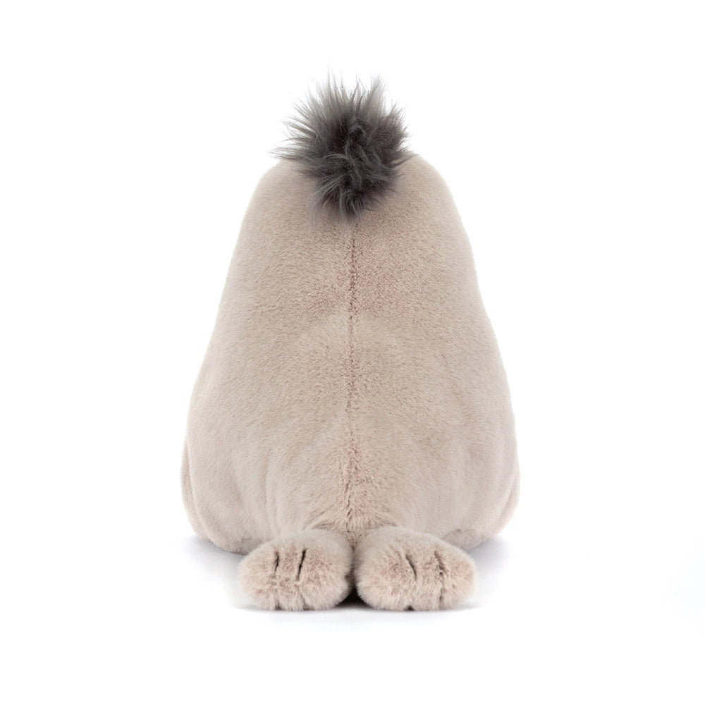 A photo of the back of a beige  sea lion plush toy on a white backround. 