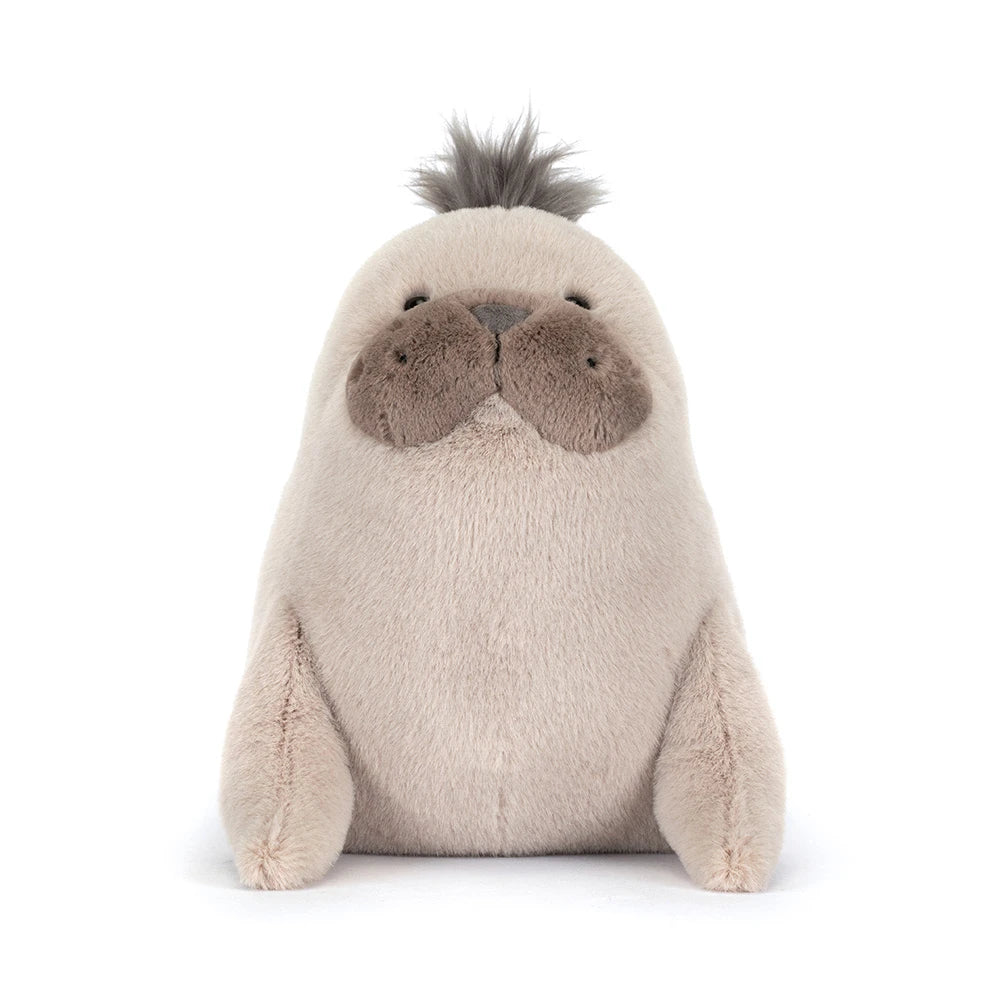 A front facing  photo of a beige sea lion plush toy on a white backround.