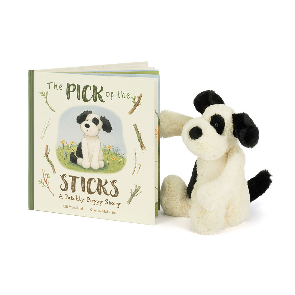 Children's book titled 'The Pick of the Sticks' with a plush puppy toy on a white background.