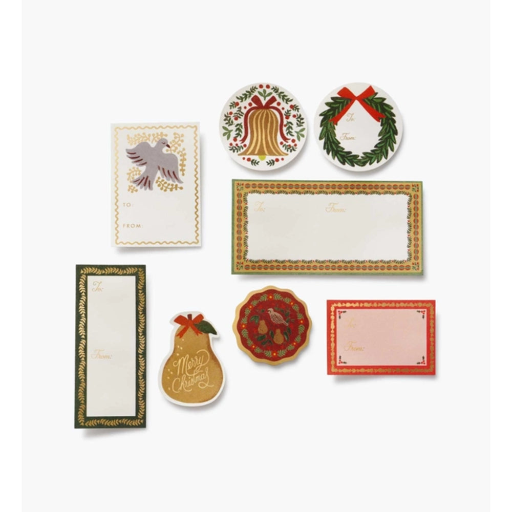 A set of Christmas-themed paper writing utensils and note cards arranged on a light gray background. The set includes a bird card, a bell-shaped notepad, a wreath notepad, a rectangular bordered notepad, a pear-shaped notepad, a round floral notepad, and a pink rectangular card.