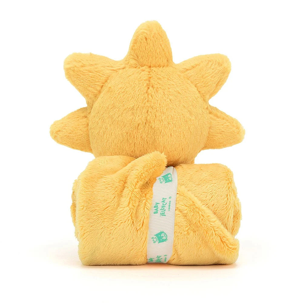 Back of a rolled yellow sun-shaped comfort blanket with smiling face sun on a white background.