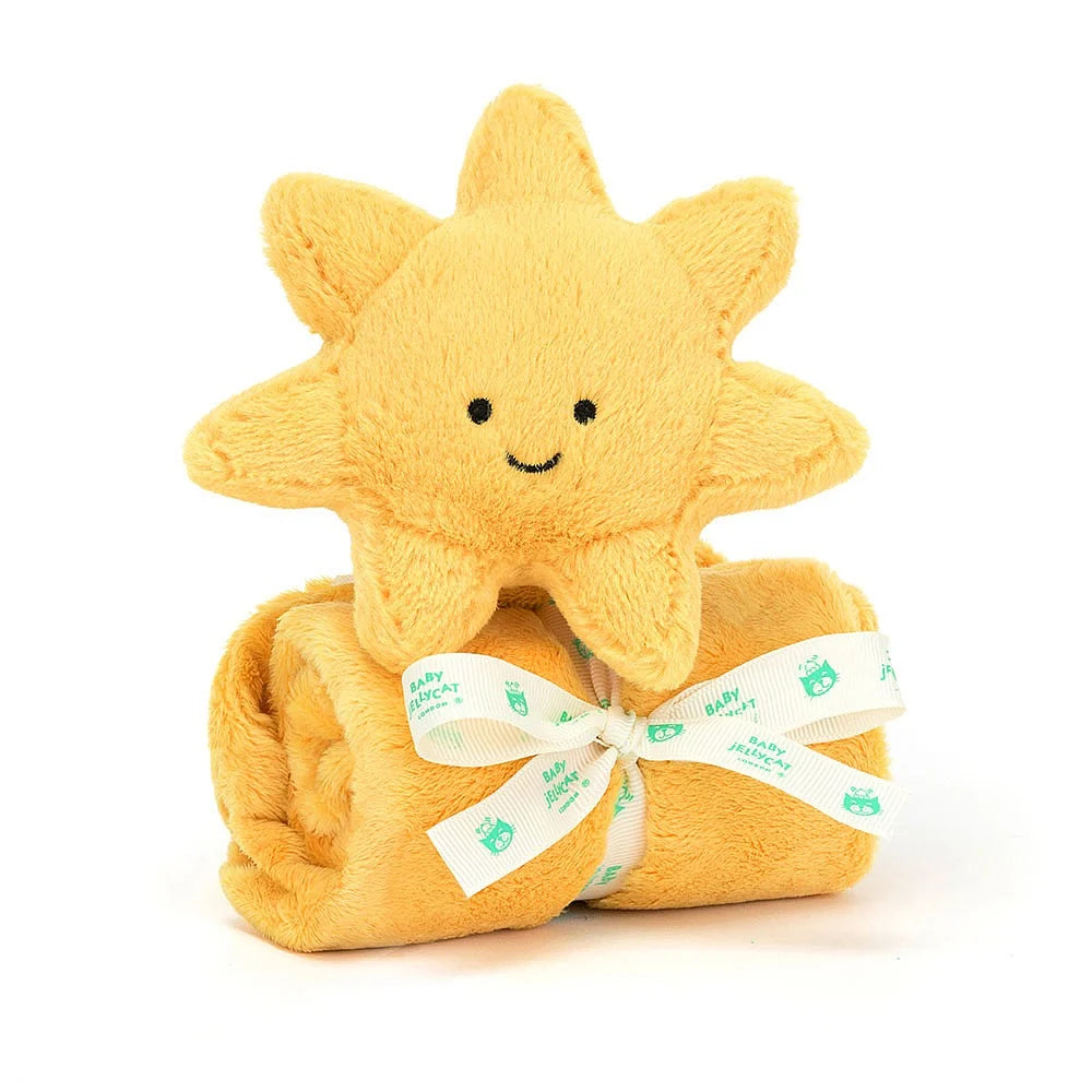 Rolled yellow sun-shaped comfort blanket with smiling face sun  on a white background.