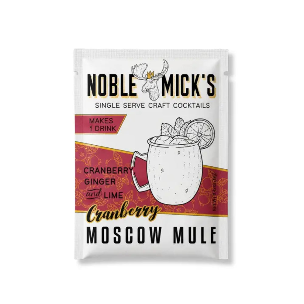 A single-serve packet of Noble Mick's Craft Cocktails Cranberry Moscow Mule, featuring a white and red design with an illustration of a mug and garnishes.