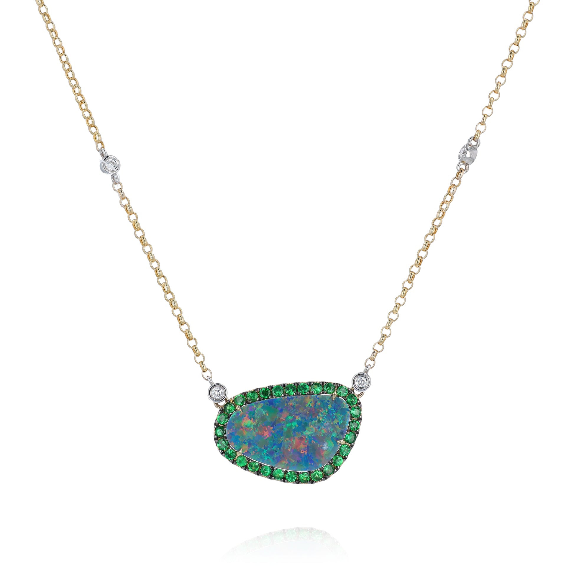 Yellow and white gold freeform opal, green tsavorite, and diamond halo pendant necklace on a white background