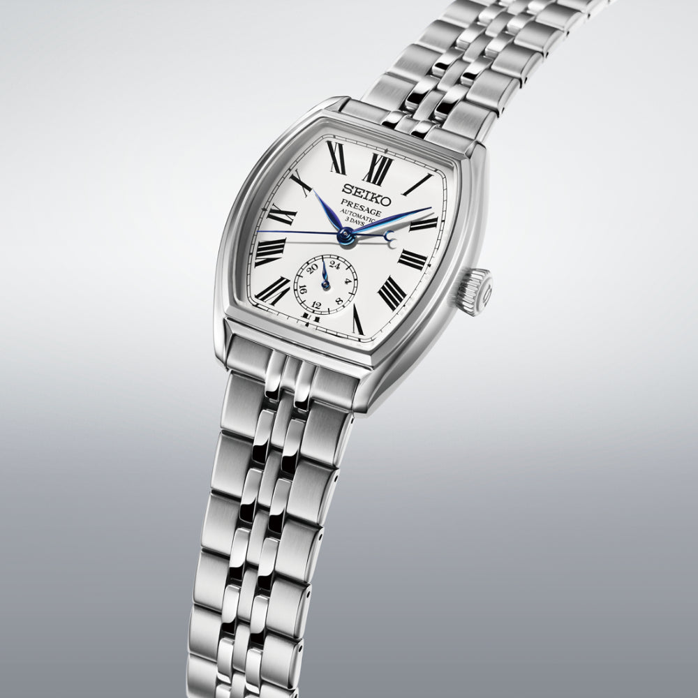 Silver Seiko watch with a white face on a light gray background