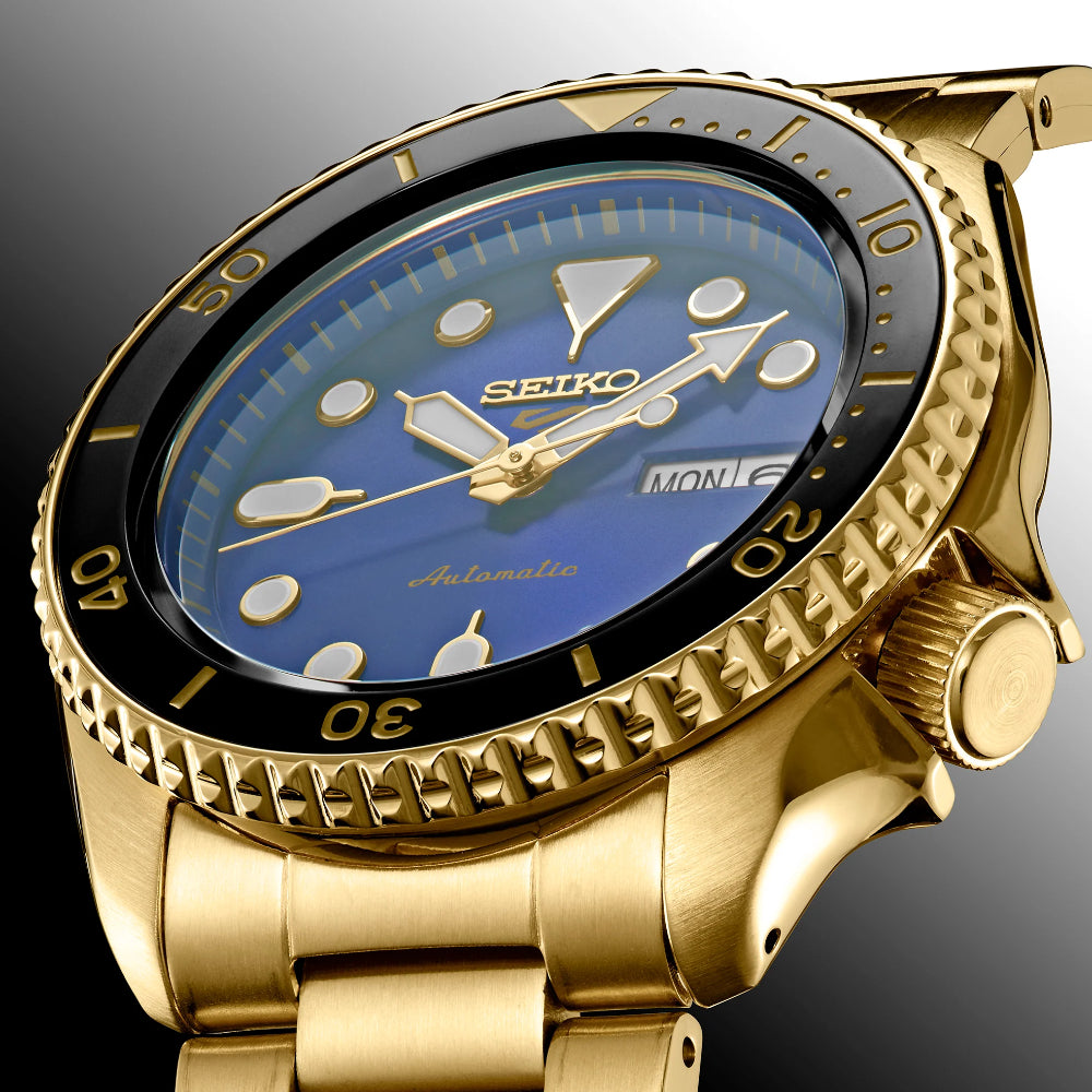 Gold Seiko watch with blue dial on a gray background