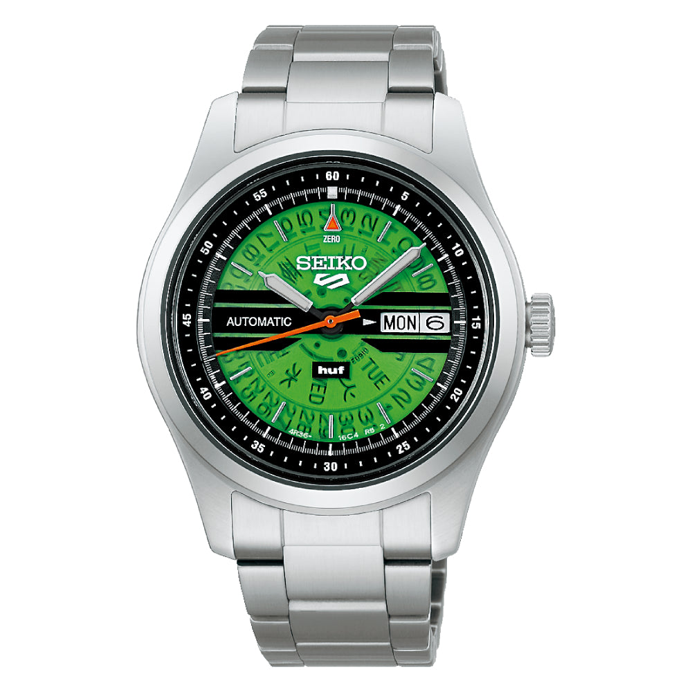 Steel Seiko watch with green "HUF" dial on a white background