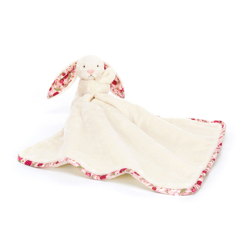 White bunny white a floral-patterned edged comfort blanket on a white background.