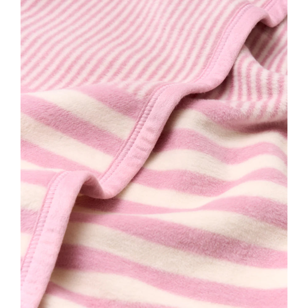 Pink and white striped mini blanket on a white background