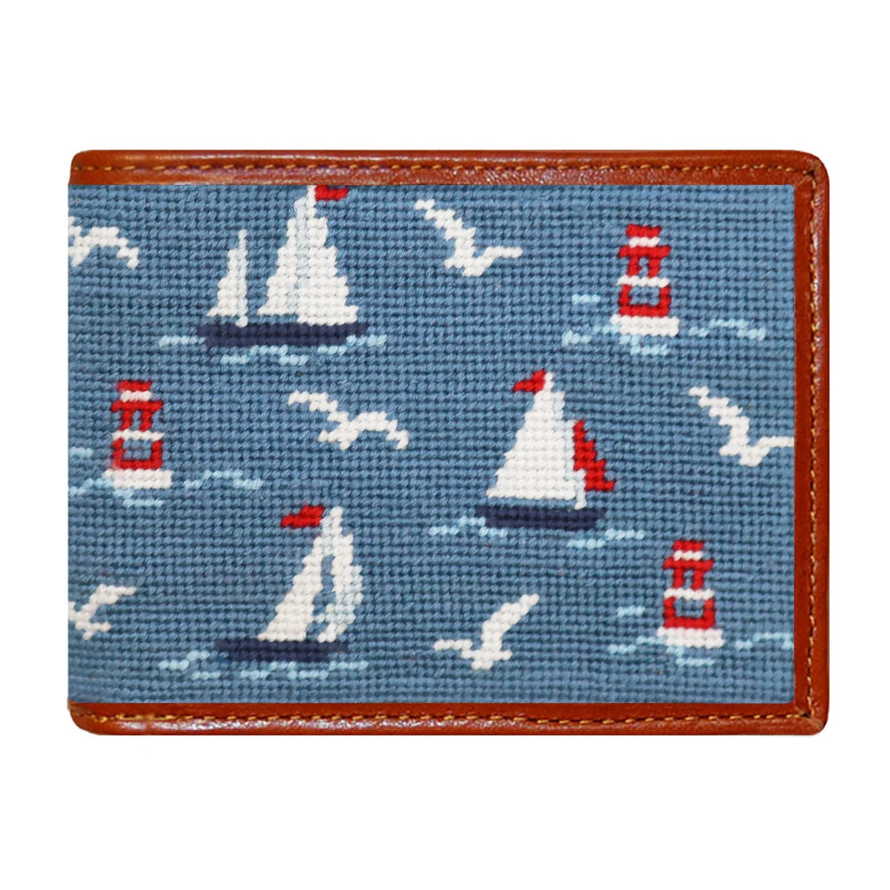 A wallet with sailboats on blue colors and a white background. 