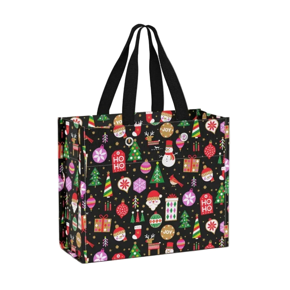 A reusable shopping tote bag with black handles, featuring a festive Christmas pattern on a black background with colorful ornaments, gifts, trees, and holiday motifs.