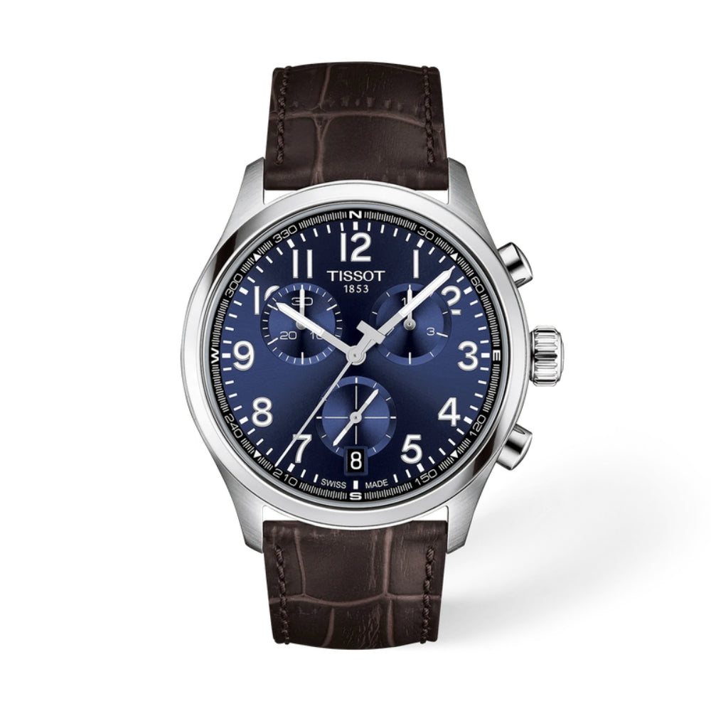 Tissot watch with blue dial and brown leather strap on a white background