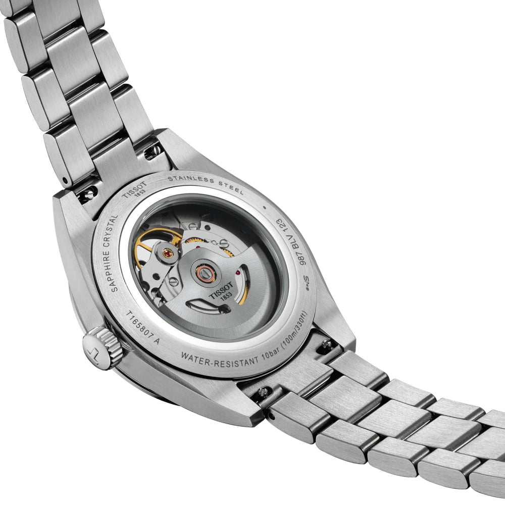 Back angle of a silver Tissot watch with visible mechanical components on a white background