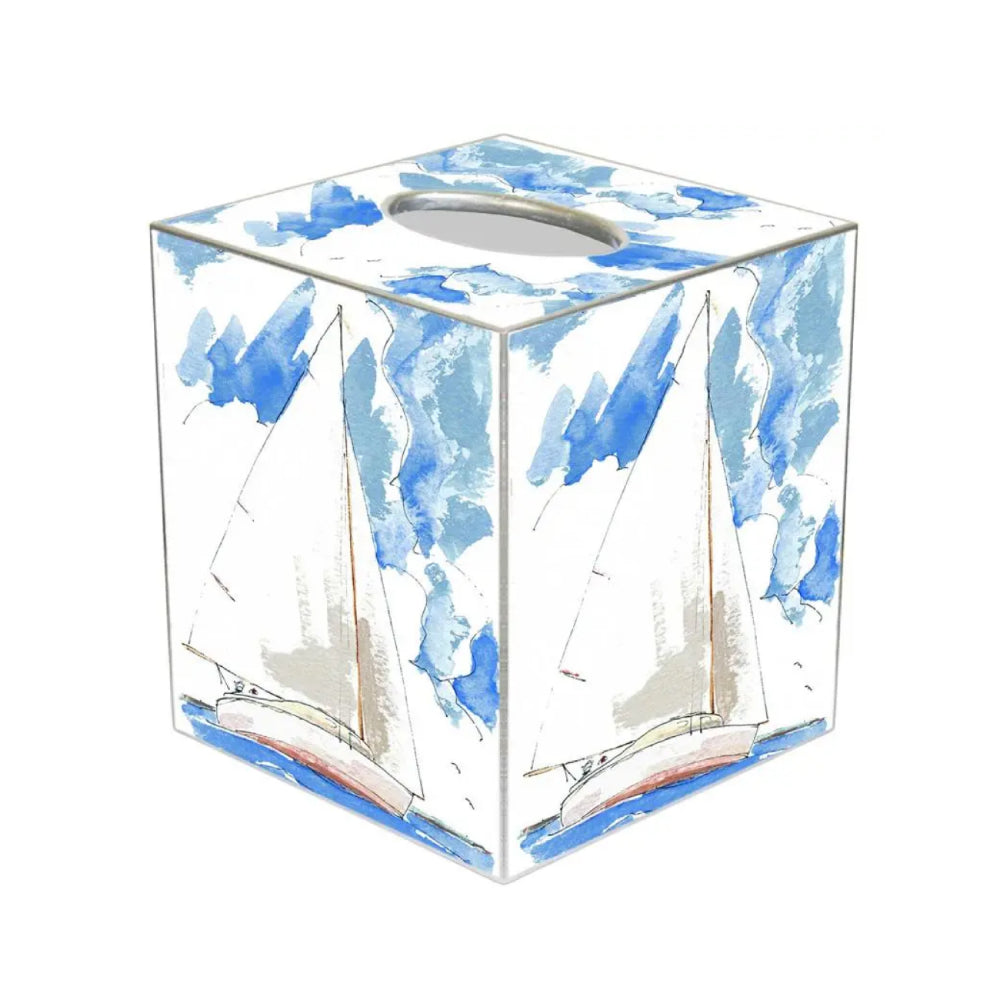 Cube-shaped paper mache  tissue box cover with a sailboat on the water against the sky on a white background