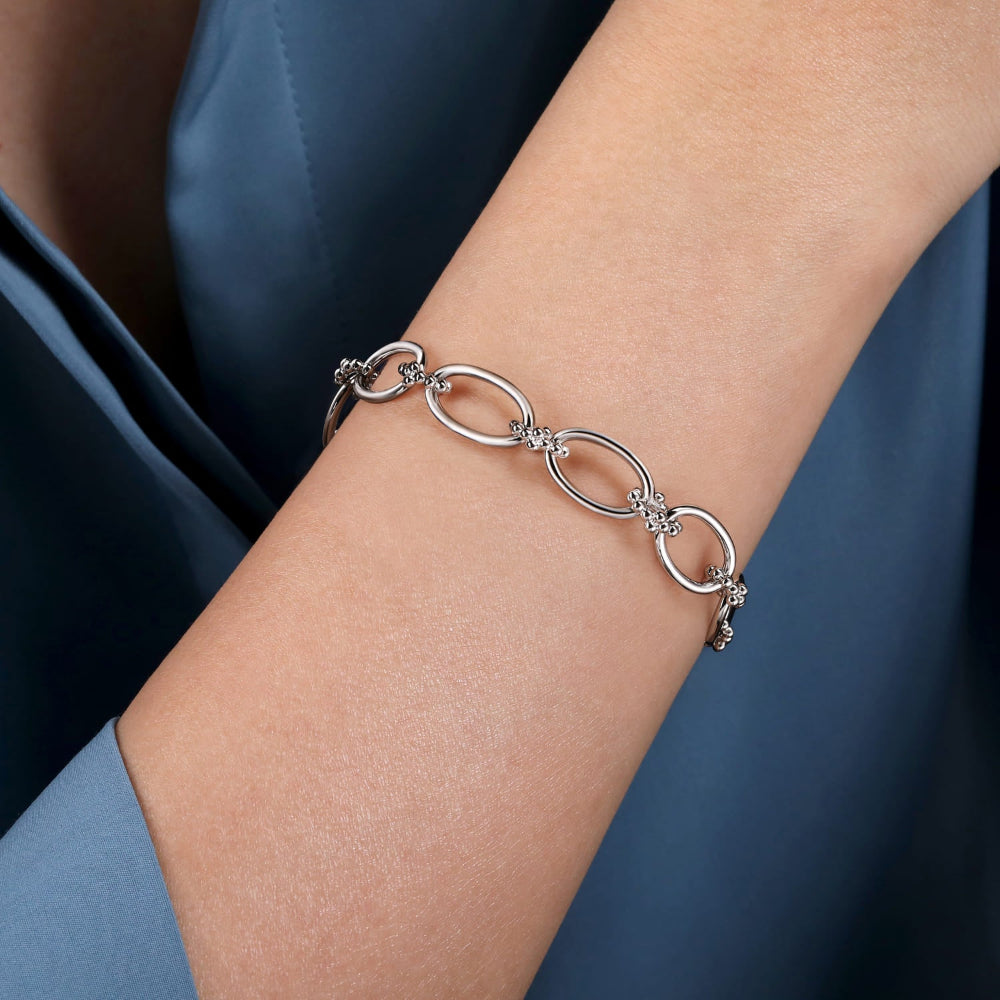 Up close on a persons arm - link chain bracelet 