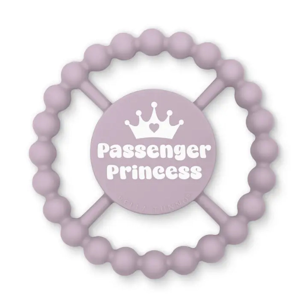 A lavender silicone baby teether with a beaded outer ring and a central circular pad featuring a white crown graphic and the text 'Passenger Princess'.