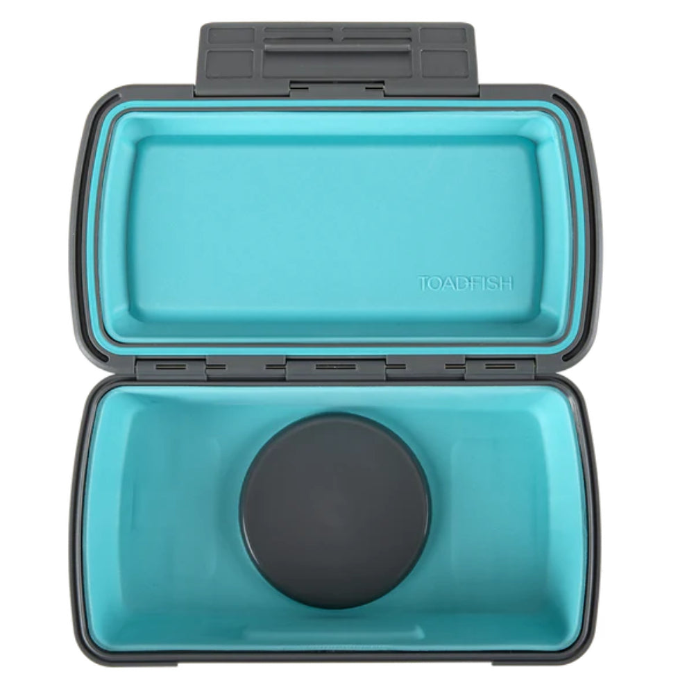 A photo looking in the top of a opened turquoise and gray box on a white backround. 
