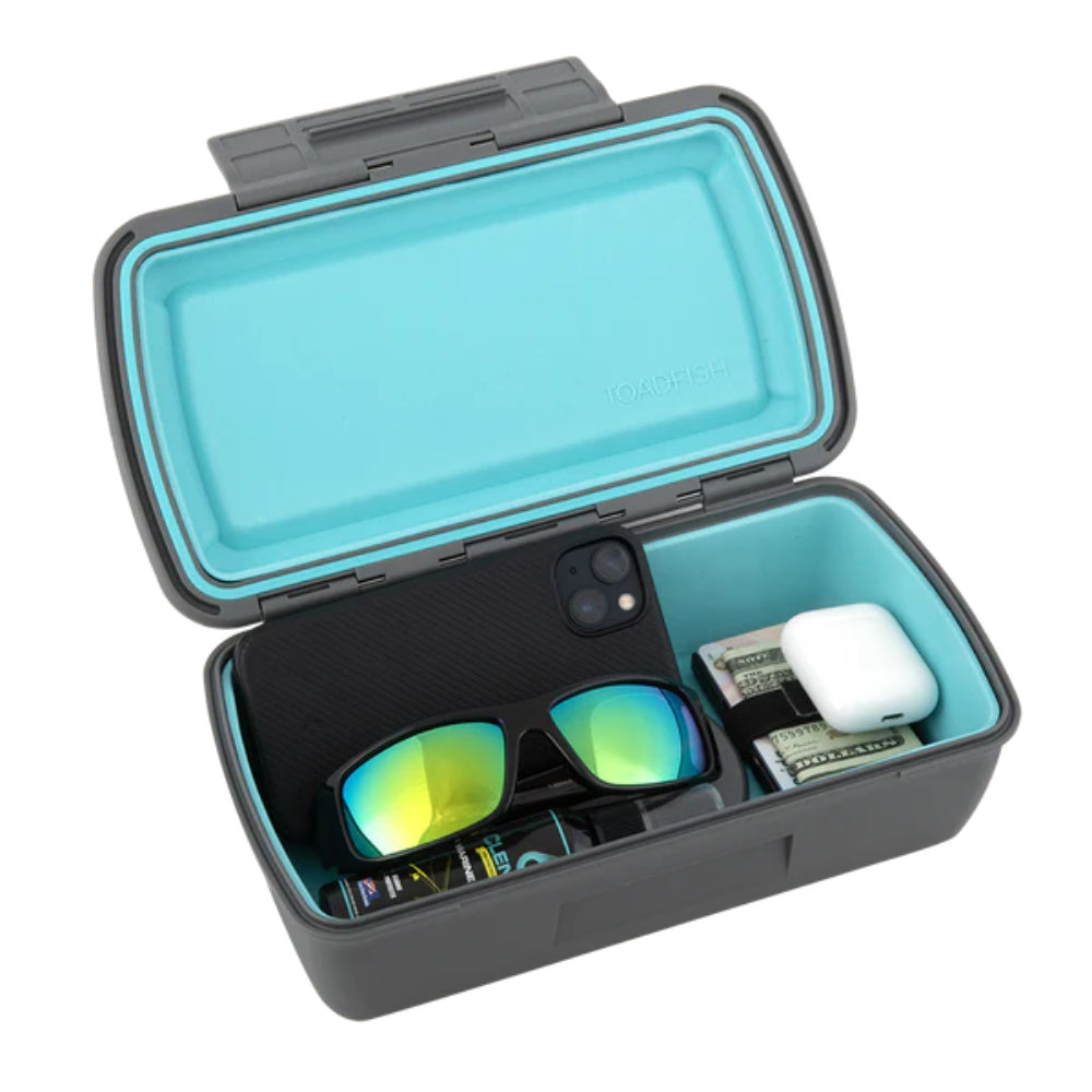 Opened turquoise and gray case with a phone, sunglasses, and other items on a white background.