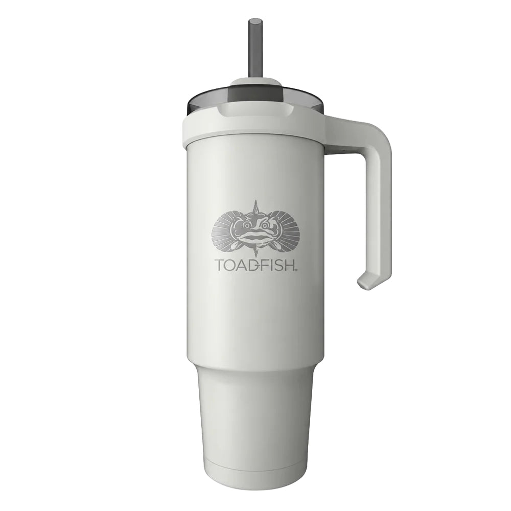 A tall white insulated tumbler with a handle, clear lid, and gray straw, featuring a gray fish logo and the word 'TOADFISH.' on the front, shown on a plain white background.