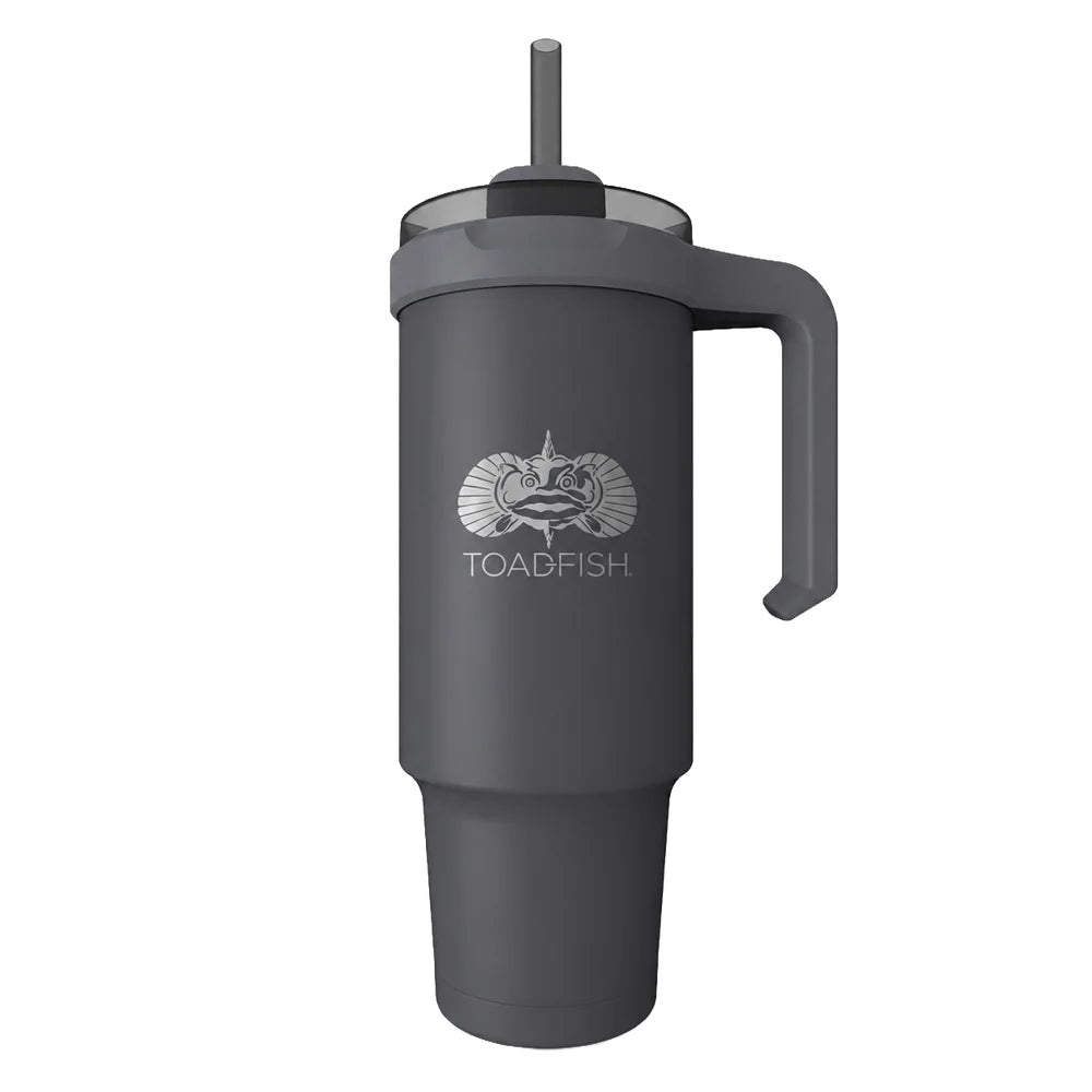 A dark gray insulated travel tumbler with a handle, lid, and straw, featuring a white printed Toadfish logo on the front, shown on a plain white background.