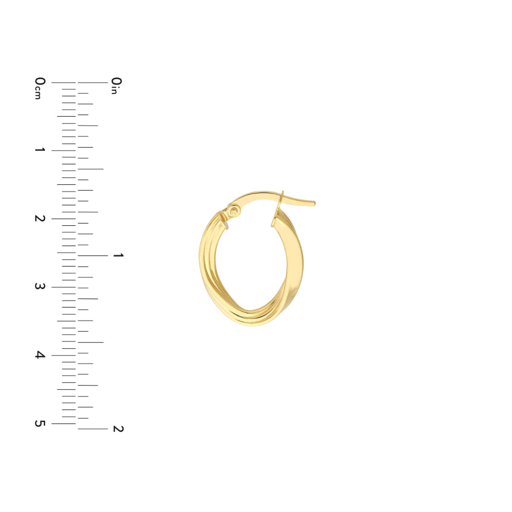 gold tone oval twisted hoop earring on white background next to scale