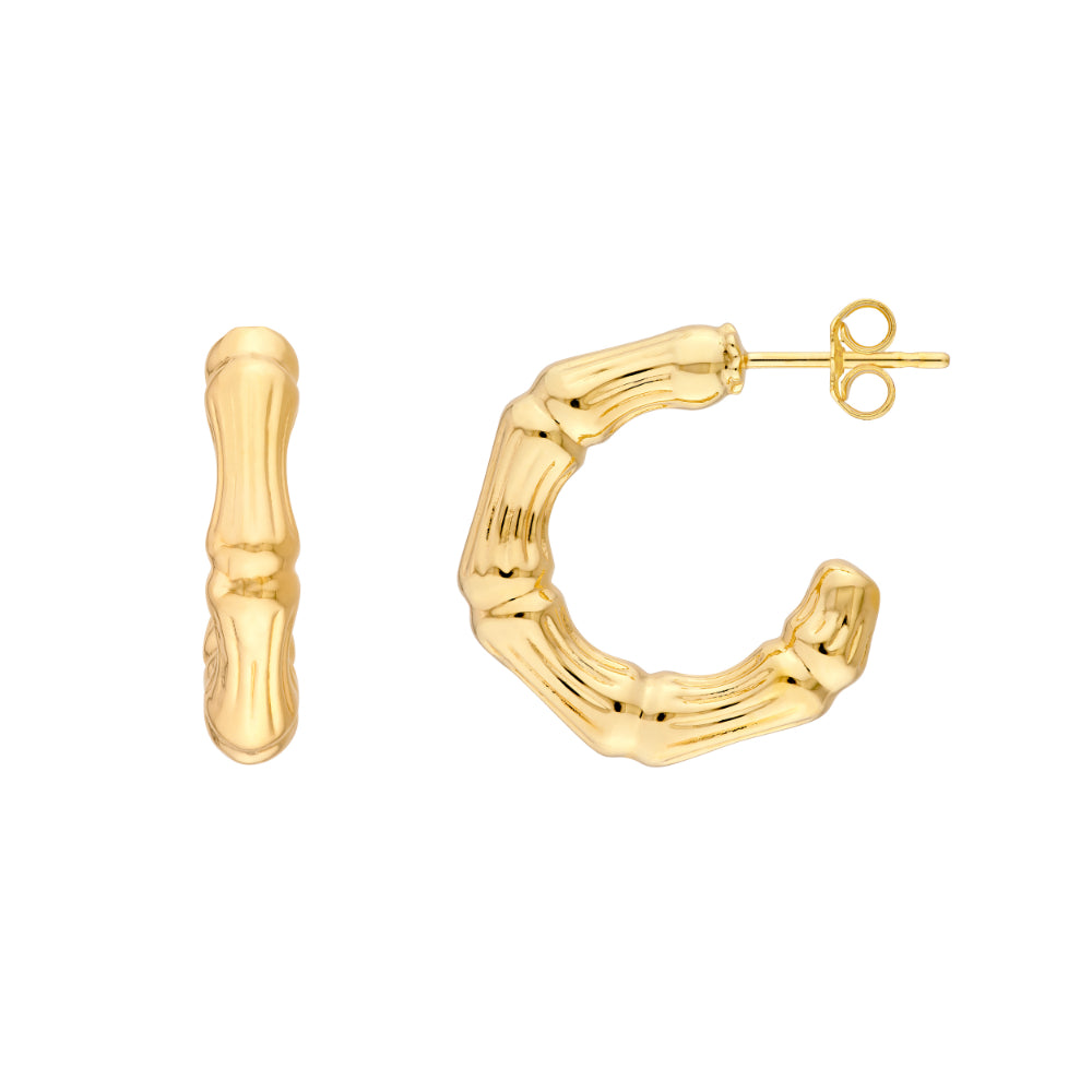 gold tone textured hoop earrings on white background