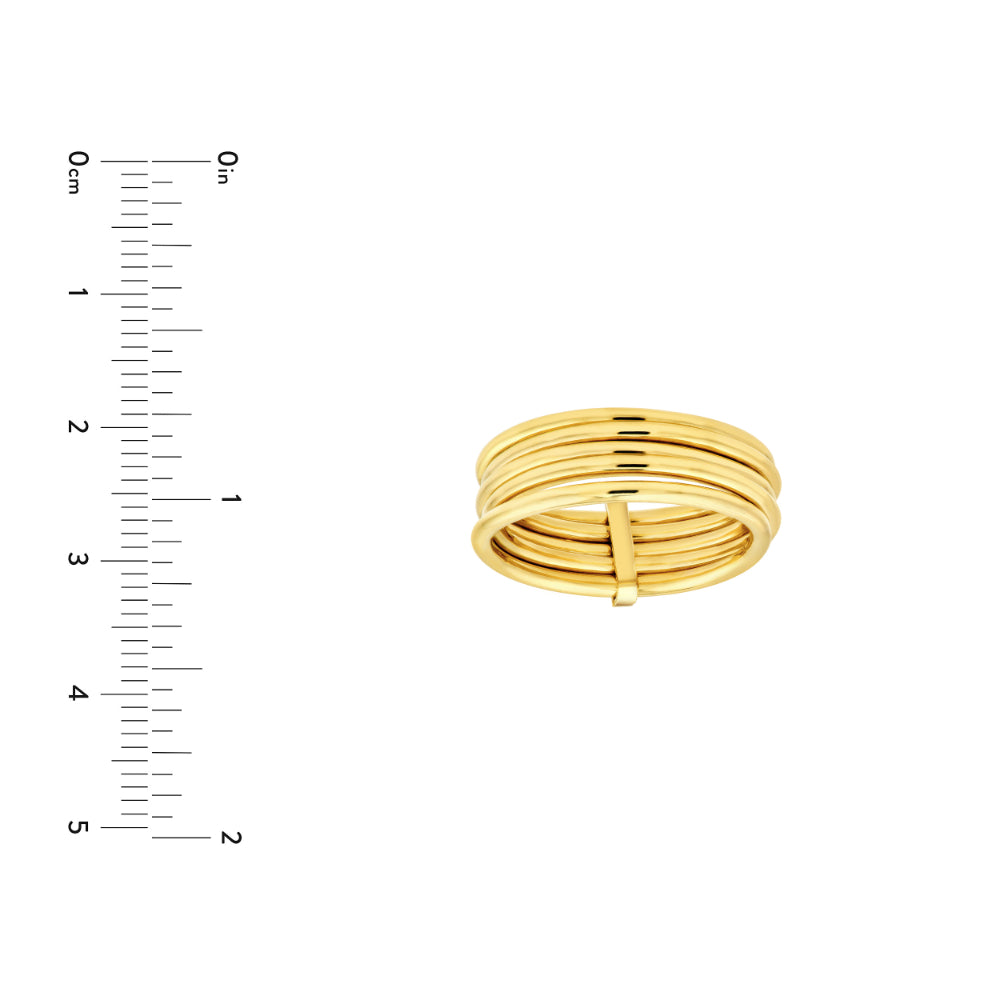 gold tone multilayer ring on white background next to scale