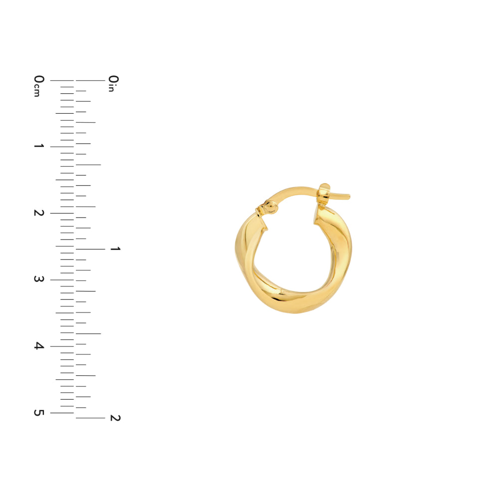 wavy gold tone hoop earrings on white background next to scale