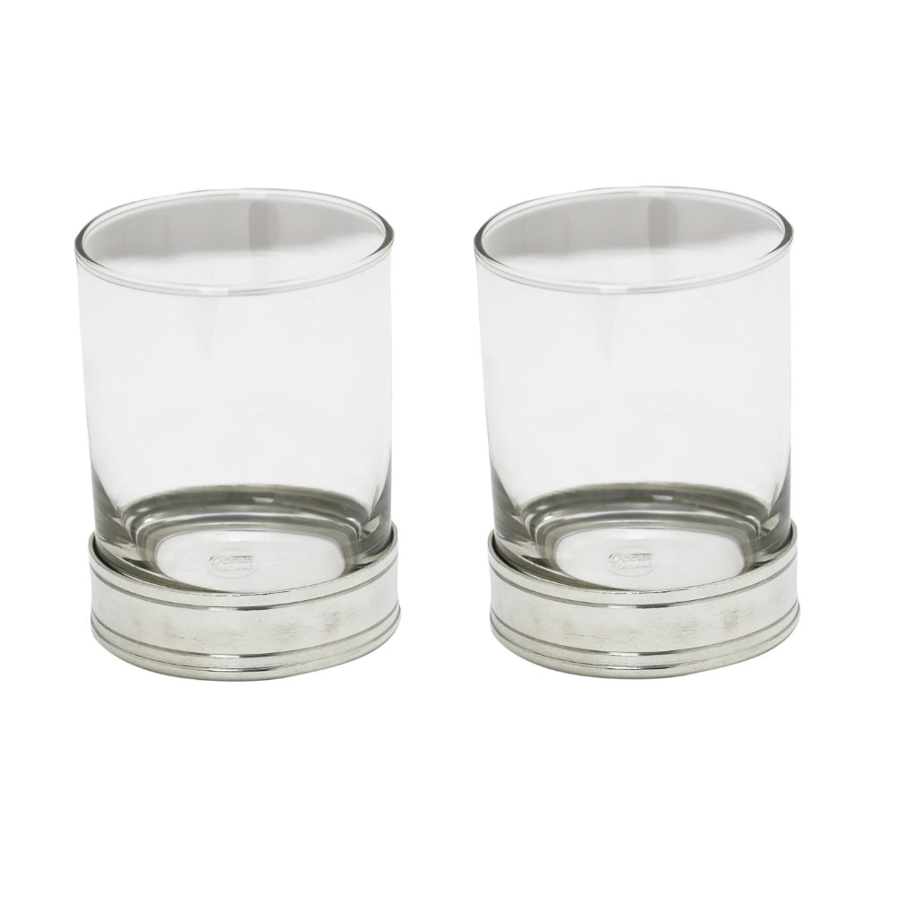 Two clear old fashioned glass with silver metallic bases on a white background.