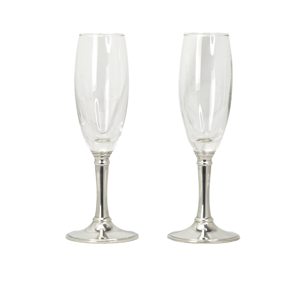 Two clear champagne flutes with silver bases on a white background.
