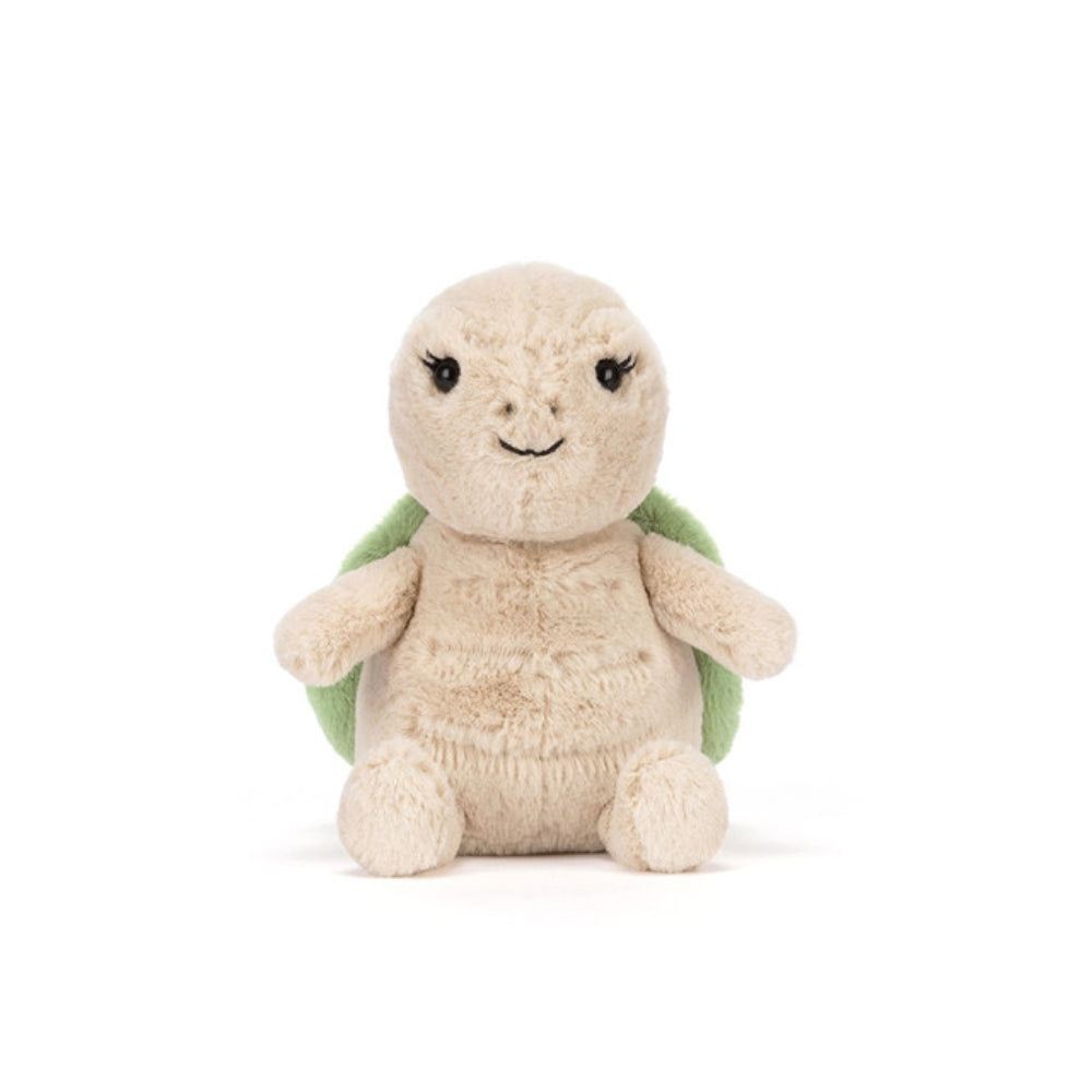 A front facing photo of the beige plush turtle toy with a smiling face and a green shell on a white background.