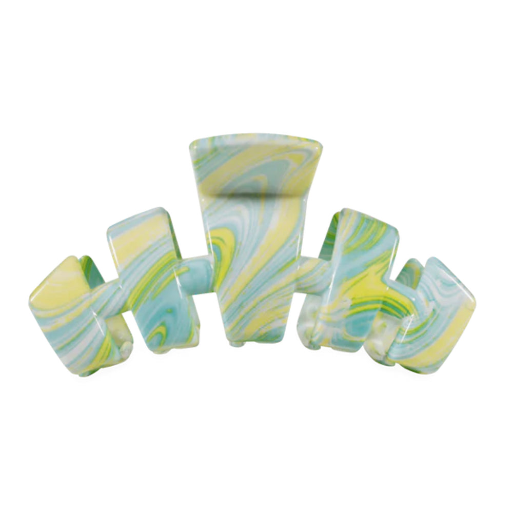 Marbled green and yellow hair clip on a white background