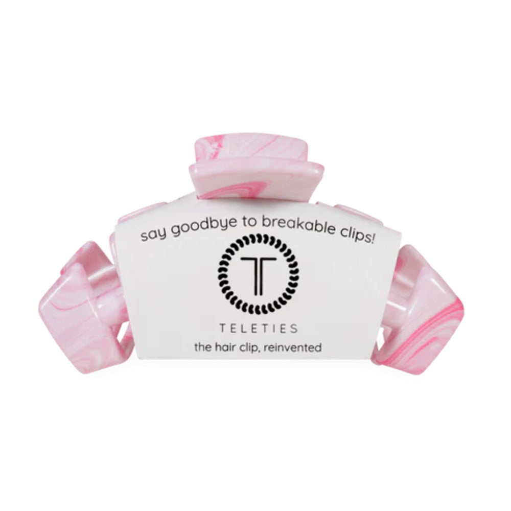 Pink hair clip with white label displaying 'Teleties' brand on a white background