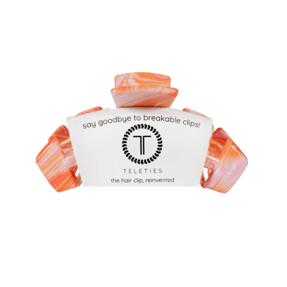 Marble-patterned hair clip with 'Teleties' branding on a white background