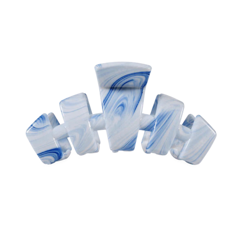 Marbled blue and white hair clip on a white background