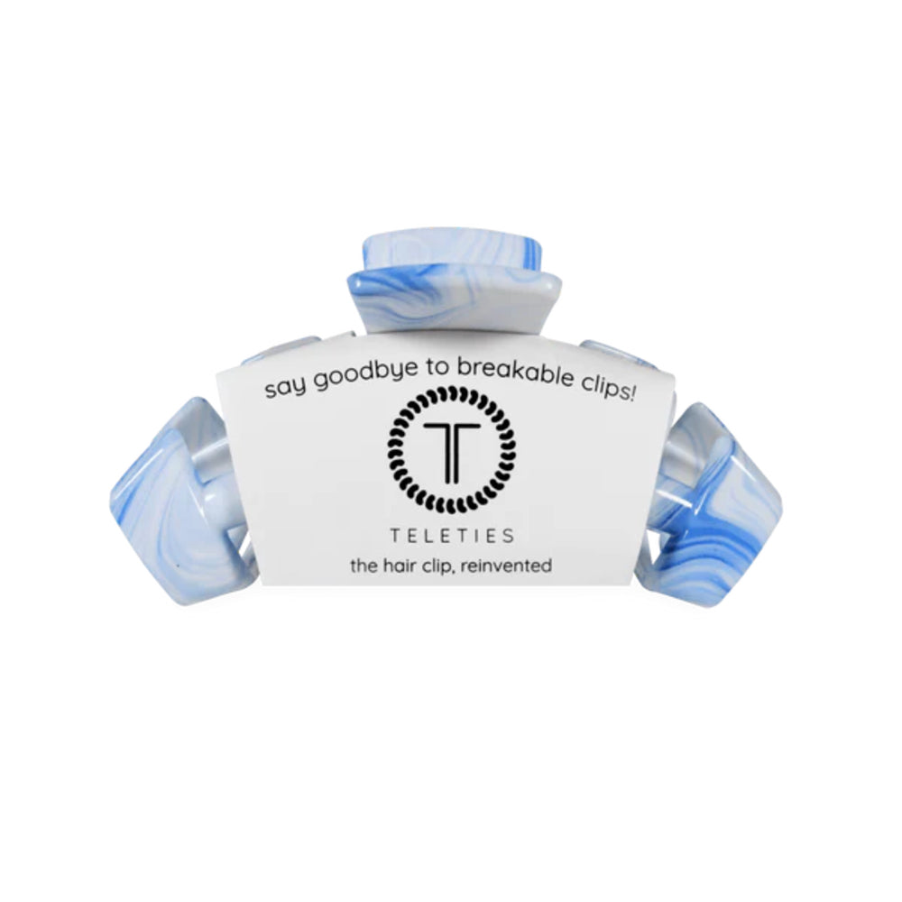 Hair clip with blue accents on a white background, featuring the brand 'Teleties'.